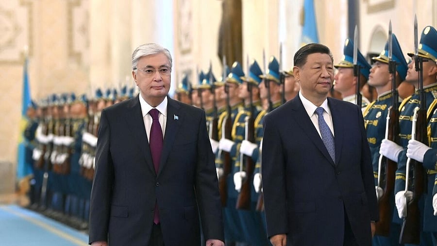 <div class="paragraphs"><p>Kazakhstan's President Kassym-Jomart Tokayev and China's President Xi Jinping walk past honour guards during a welcoming ceremony before their talks in Astana.</p></div>