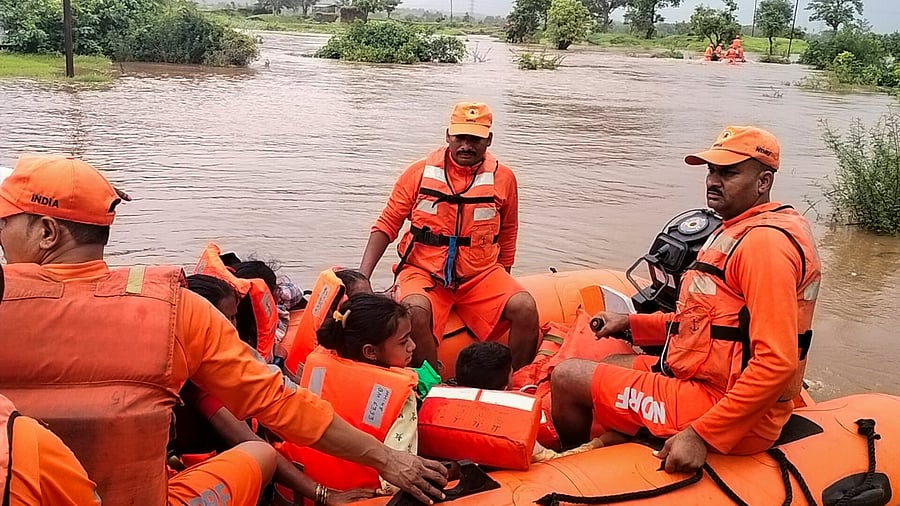 <div class="paragraphs"><p>NDRF personnel rescue people from a flood affected area following heavy rainfall, at Usgaon in Palghar district on Sunday, July 7, 2024. </p></div>