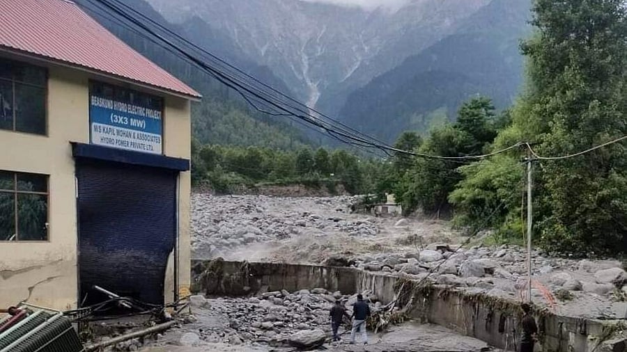<div class="paragraphs"><p>People stand near debris after flash floods triggered by cloud burst, near Manali, Thursday, July 25, 2024</p></div>