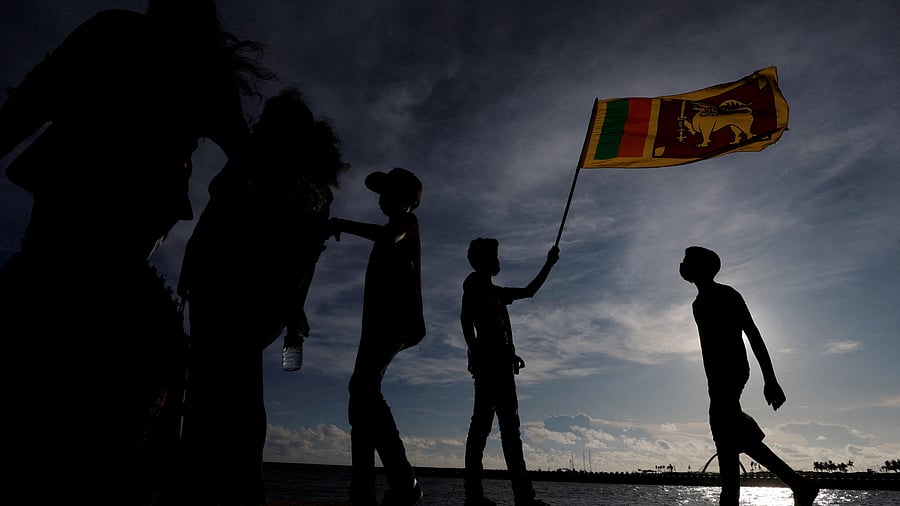 <div class="paragraphs"><p>Man holds a Sri Lankan national flag</p></div>