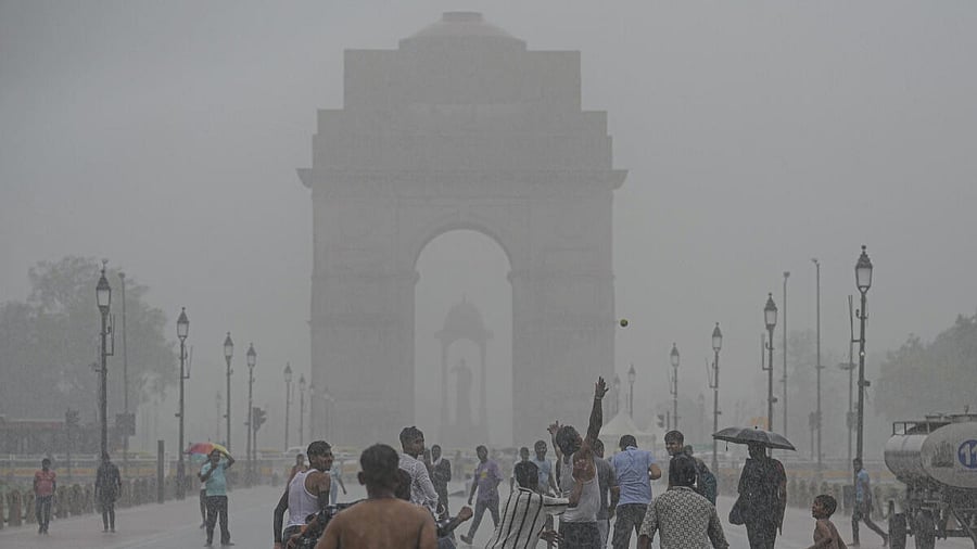 <div class="paragraphs"><p>People play at the India Gate amid rains, in New Delhi.</p></div>