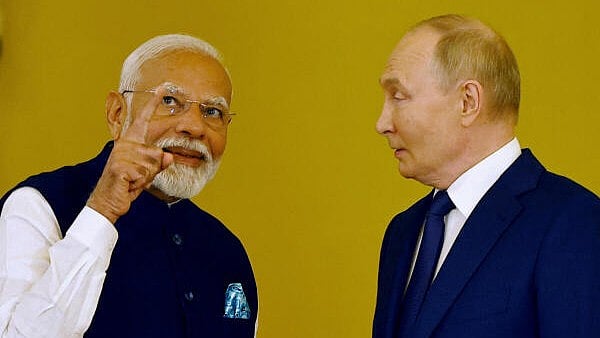 <div class="paragraphs"><p>Russia's President Vladimir Putin talks to India's Prime Minister Narendra Modi before awarding him the Order of St. Andrew the Apostle the First-Called at the Kremlin in Moscow, Russia. </p></div>