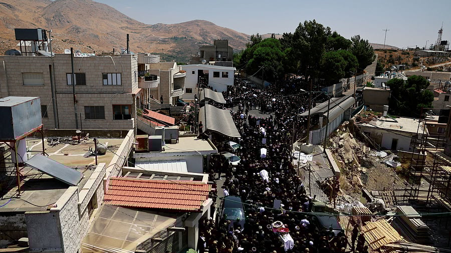 <div class="paragraphs"><p>Mourners carry coffins, during the funeral of children who were killed at a soccer pitch by a rocket fired from Lebanon, in Majdal Shams, a Druze village in the Israeli-occupied Golan Heights, July 28, 2024. </p></div>