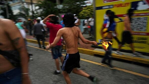 <div class="paragraphs"><p>A protester runs with a Molotov cocktail as Venezuelan opposition supporters protest following the announcement by the National Electoral Council that Venezuela's President Nicolas Maduro won the presidential election, in Caracas, Venezuela July 29, 2024.</p></div>
