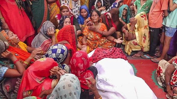 <div class="paragraphs"><p>Relatives mourn near the body of a victim a day after a stampede that occured during a 'satsang' (religious congregation), in Sikandra Rao area of Hathras district.</p></div>