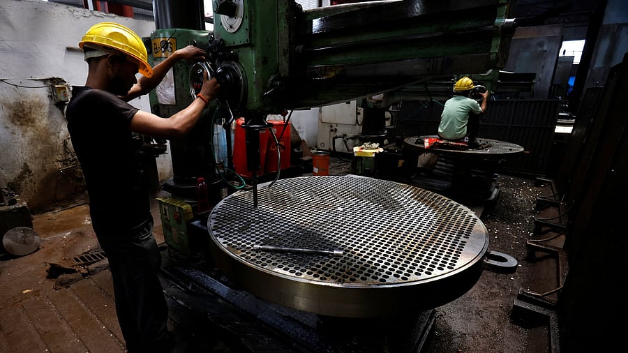<div class="paragraphs"><p>A worker makes a metal filter plate inside an industrial manufacturing unit on the outskirts of Ahmedabad, India, July 23, 2024.</p></div>
