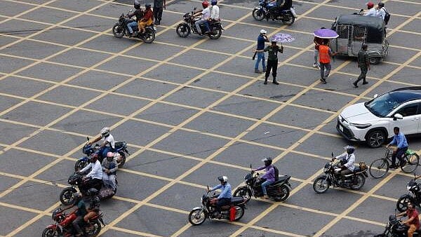 <div class="paragraphs"><p>Vehicles move on the road as civilians and members of Bangladesh Ansar, a paramilitary force, jointly control traffic at Bijoy Sarani intersection, days after the resignation of former Prime Minister Sheikh Hasina, in Dhaka, Bangladesh, August 7, 2024.</p></div>