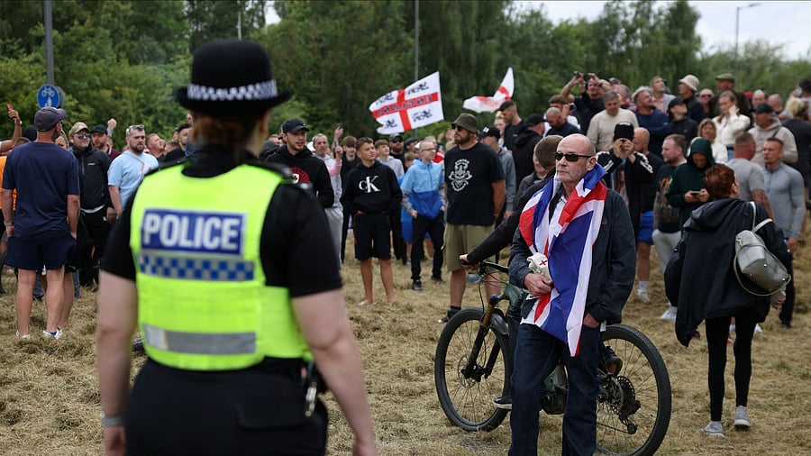 <div class="paragraphs"><p>A police officer stands guard facing towards anti-immigration protesters in Rotherham, Britain, August 4, 2024.</p></div>