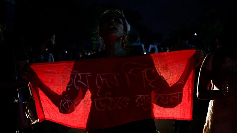 <div class="paragraphs"><p>A woman attends a vigil condemning the rape and murder of a trainee medic at a government-run hospital in Kolkata.</p></div>
