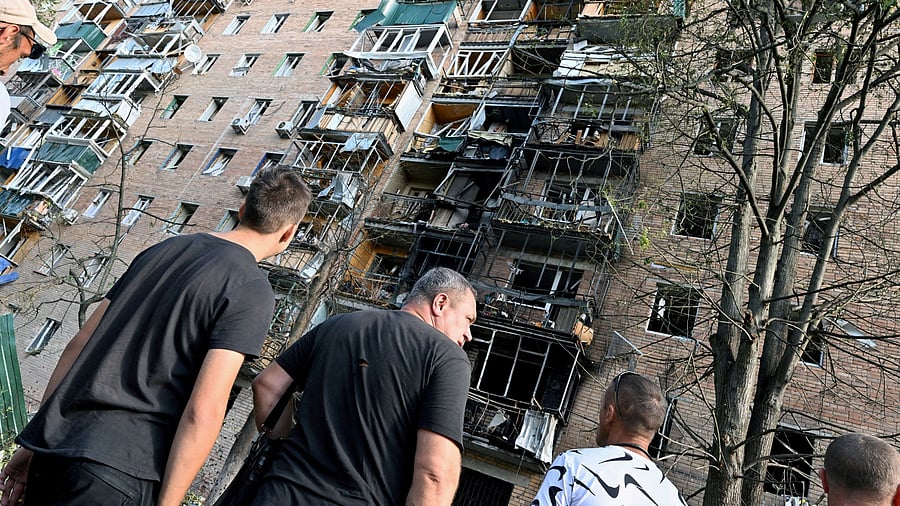 <div class="paragraphs"><p> People gather in the courtyard of a multi-storey residential building, which according to local authorities was hit by debris from a destroyed Ukrainian missile, in the course of Russia-Ukraine conflict in Kursk, Russia August 11, 2024. </p></div>