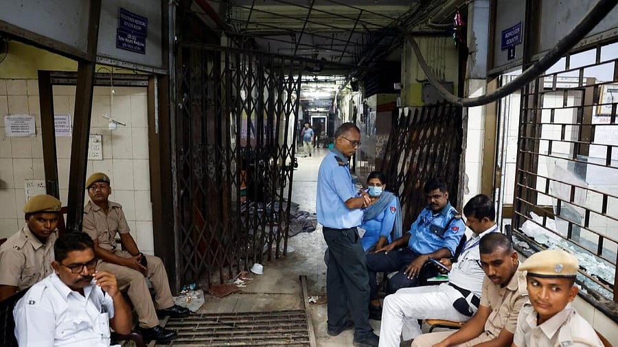 <div class="paragraphs"><p>Security officials sit at the entrance of the medical emergency ward that was vandalisedat Kolkata's R G kar hospital. </p></div>