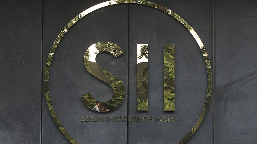 <div class="paragraphs"><p>A man's reflection is seen in the logo of the Serum Institute of India, inside the facility in Pune, India.</p></div>