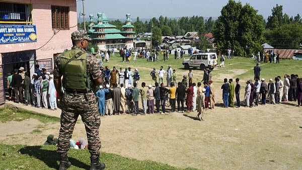 <div class="paragraphs"><p>Voters wait to cast their votes during this year's Lok Sabha elections in Budgam district of central Kashmir.</p></div>