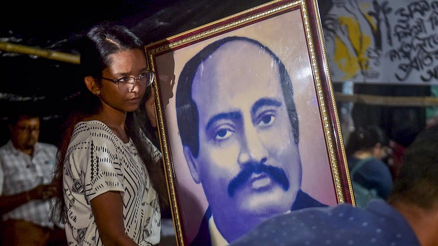 <div class="paragraphs"><p>A doctor holds a portrait of Radha Gobinda Kar, founder of the RG Kar Medical College and Hospital, on his birth anniversary, during a protest against the alleged rape and murder of a trainee woman doctor inside the hospital, in Kolkata.&nbsp;</p></div>