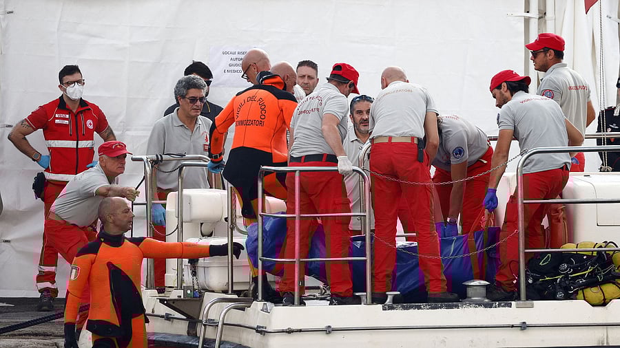 <div class="paragraphs"><p>Rescue personnel stand near the body bag containing the corpse of British entrepreneur Mike Lynch, who died when a yacht owned by his family sank off the coast of Porticello, near the Sicilian city of Palermo, Italy.</p></div>