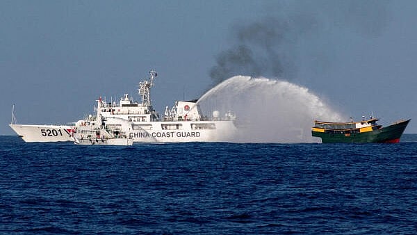 <div class="paragraphs"><p>Chinese Coast Guard vessels fire water cannons towards a Philippine resupply vessel Unaizah on its way to a resupply mission at Second Thomas Shoal in the South China Sea earlier this year.</p></div>