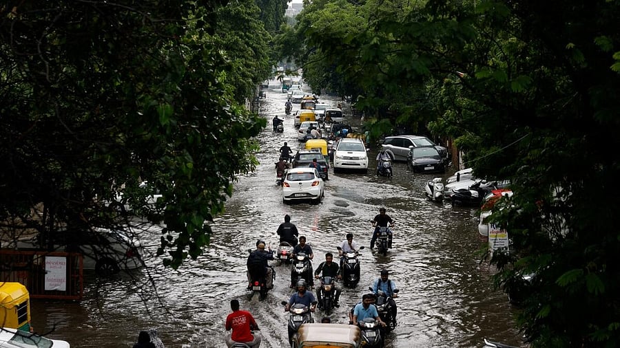 <div class="paragraphs"><p>Traffic moves through a flooded road after heavy rains in Ahmedabad, Gujarat.&nbsp;</p></div>