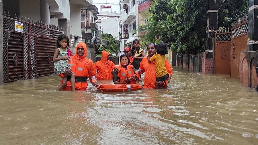 <div class="paragraphs"><p>NDRF personnel rescue people from their flood-affected residence after heavy rains, in Ranchi.</p></div>