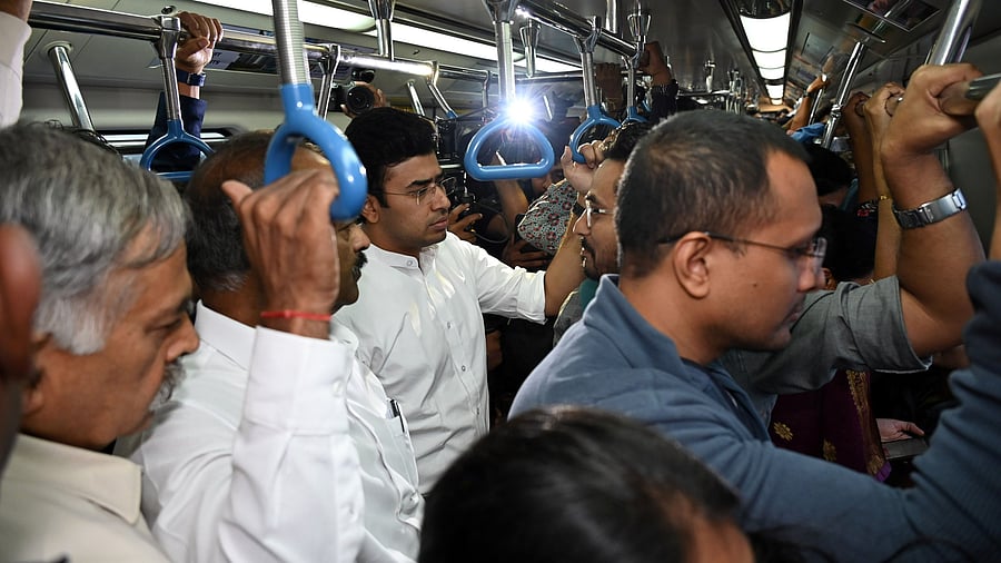 <div class="paragraphs"><p>MPs Tejasvi Surya and PC Mohan interact with metro passengers as they take a ride from KR Pura to Majestic on Monday. </p></div>