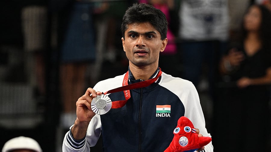 <div class="paragraphs"><p>India's Suhas Yathiraj celebrates on the podium with his second Paralympics silver medal in Paris. </p></div>