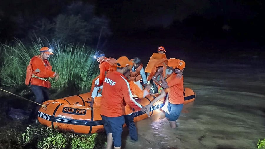 <div class="paragraphs"><p>NDRF personnel evacuate people from a flood-affected area of Telangana. </p></div>