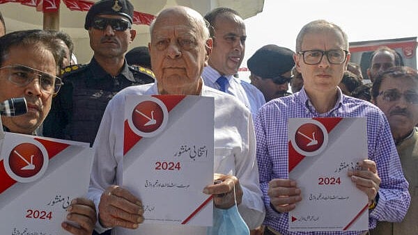 <div class="paragraphs"><p>National Conference President Farooq Abdullah with his son and party Vice President Omar Abdullah releases Urdu version of party election manifesto while paying tribute to his father and party founder Sheikh Muhammad Abdullah on his death anniversary, in Srinagar. </p></div>