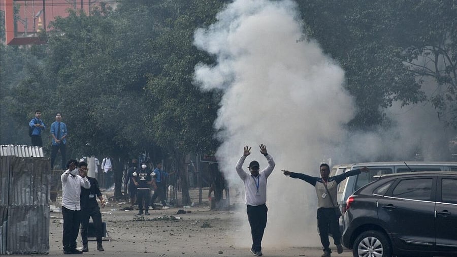 <div class="paragraphs"><p>Smoke billows from a tear gas shell fired by police to disperse the protesters in Manipur. </p></div>