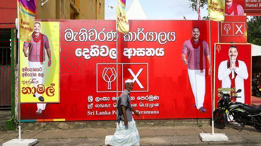 <div class="paragraphs"><p>A man walks past an election banner of presidential candidate Namal Rajapaksa outside the Sri Lanka Podujana Peramuna  party office, ahead of the upcoming presidential election scheduled for September 21, in Dehiwala, near Colombo, Sri Lanka, September 8, 2024. </p></div>