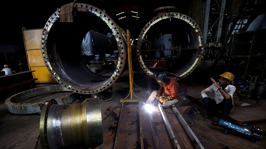 <div class="paragraphs"><p>A worker welds a cooling coil plate inside an industrial manufacturing unit on the outskirts of Ahmedabad, India </p></div>