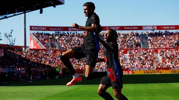 <div class="paragraphs"><p>Barcelona's Lamine Yamal celebrates scoring their first goal against Girona with teammate Jules Kounde.</p></div>