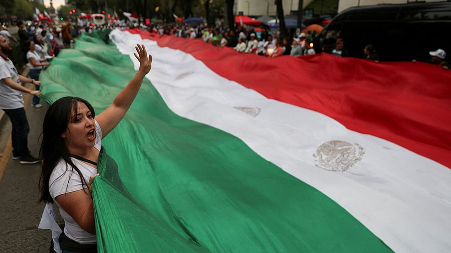 <div class="paragraphs"><p>Demonstrators display a large Mexico flag during a protest against the controversial overhaul of the country's judiciary, which would usher in a new era of elections for all judges, outside the Senate building in Mexico City, Mexico. </p></div>