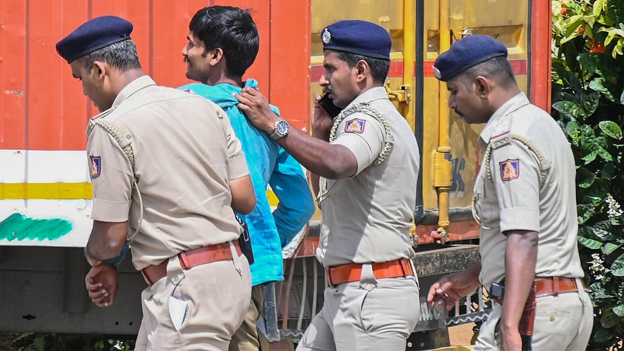 <div class="paragraphs"><p>Police whisk away Mahadev Nayak from the Vidhana Soudha premises. </p></div>