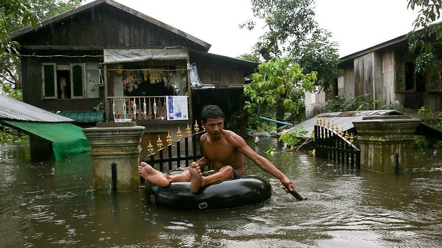 <div class="paragraphs"><p>A man travels through a flooded street in Myanmar. </p></div>