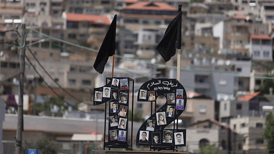 <div class="paragraphs"><p>Pictures of children and black flags are displayed killed at a soccer pitch by a rocket which Israel says was fired from Lebanon in July 2024. Representative image.</p></div>
