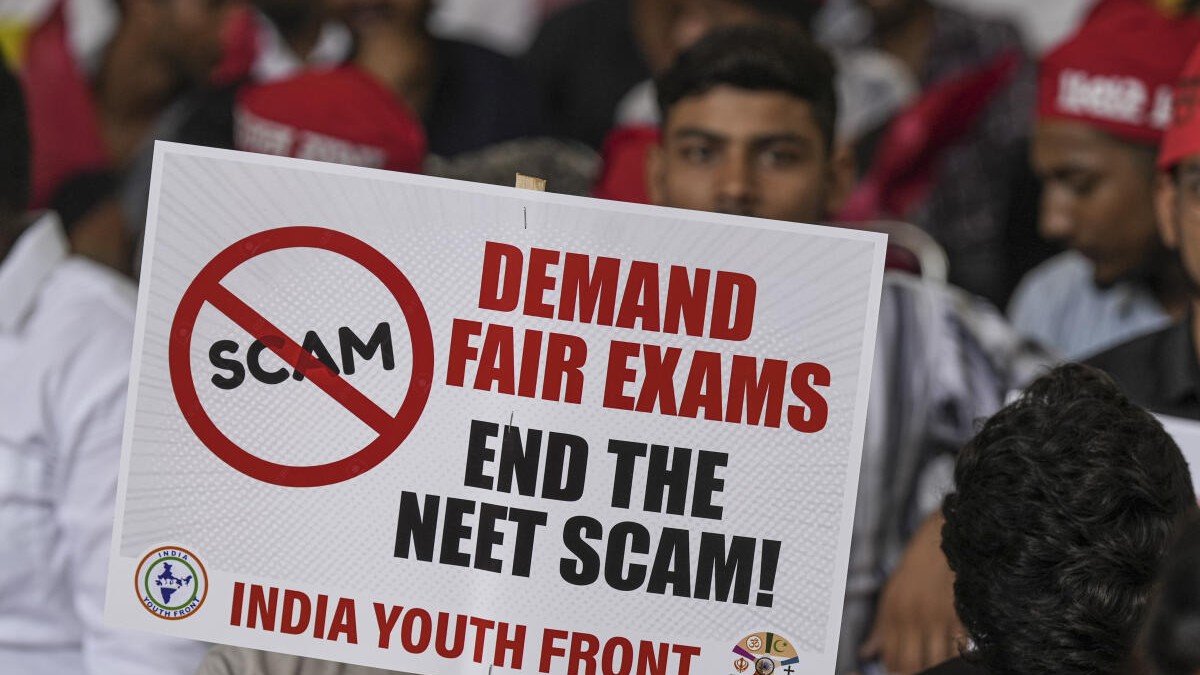 <div class="paragraphs"><p>An agitator holds a placard during a protest over the alleged irregularities in NEET 2024 results. </p></div>