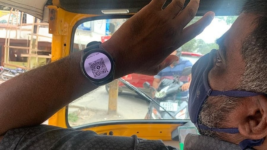 <div class="paragraphs"><p>Picture of the autorickshaw driver who accepts Payment Via Smartwatch QR Code.</p></div>