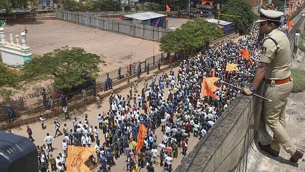 <div class="paragraphs"><p>A police man keeps vigil devotees take part in a procession for the immersion of Lord Ganesha idol in Karnataka. </p></div>