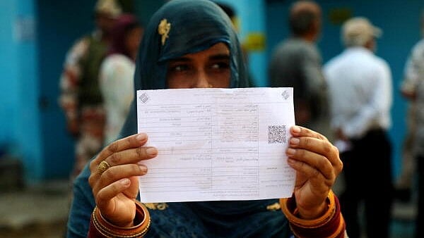 <div class="paragraphs"><p>A woman voter shows her identification card outside a polling station during the second phase of J & K Assembly polls, at Lamberi in Nowshera, in Rajouri district.</p></div>