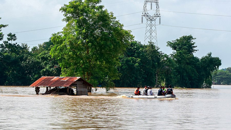 <div class="paragraphs"><p>Volunteers ride a boat through a flooded area, searching for stranded people following the impact of Typhoon Yagi. </p></div>