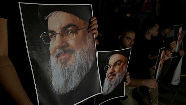 <div class="paragraphs"><p>Supporters of Sayyed Hassan Nasrallah carry his pictures.</p></div>