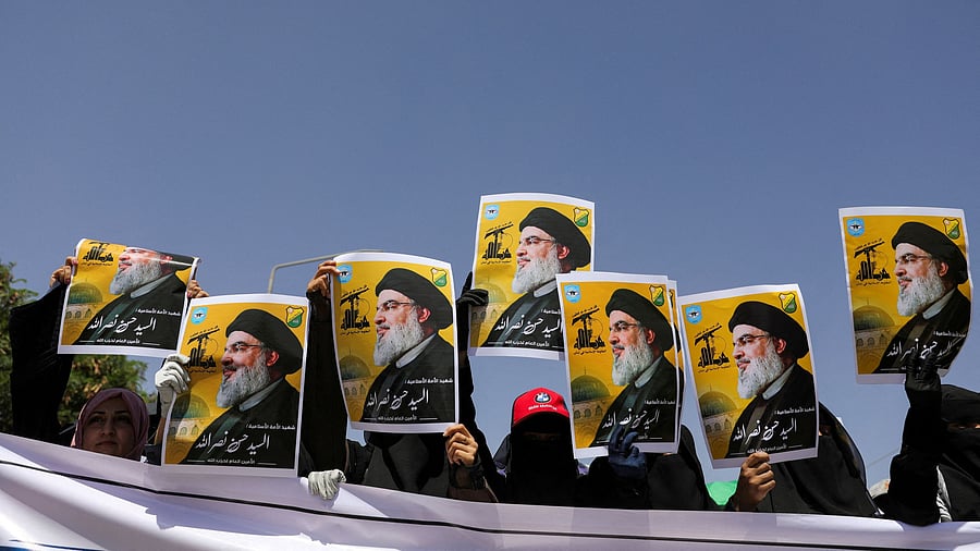 <div class="paragraphs"><p>Students hold posters of Hassan Nasrallah, the assassinated chief of Lebanon's Hezbollah, during a rally in Sanaa</p></div>