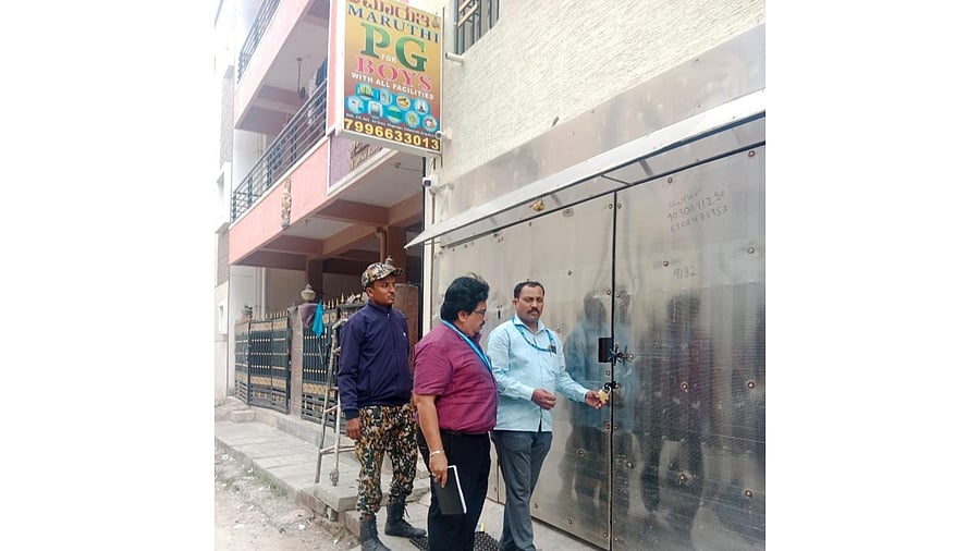 <div class="paragraphs"><p>Civic officials seal an unauthorised/illegal paying guest accommodation in the city on Thursday. </p></div>