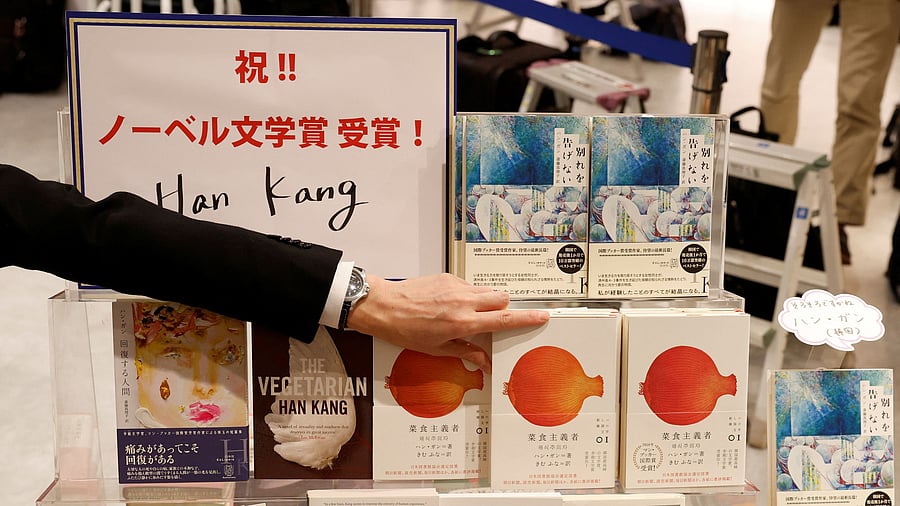 <div class="paragraphs"><p>A staff of Kinokuniya bookstore displays a book of the winner of the 2024 Nobel Prize in Literature, South Korean author Han Kang, at the book store in Tokyo, Japan October 10, 2024. </p></div>