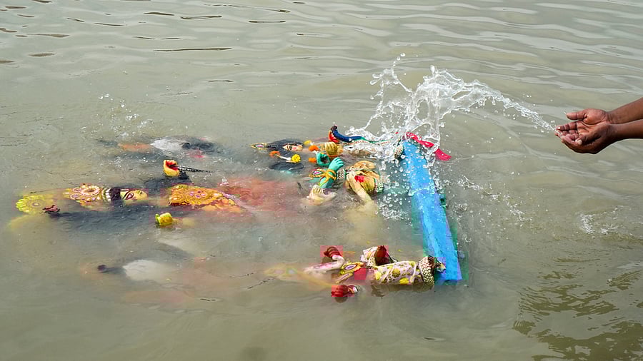 <div class="paragraphs"><p>Representative image showing a devotee immersing an idol of Goddess Durga.</p></div>