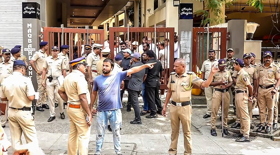<div class="paragraphs"><p>Police personnel gather outside the residence of NCP leader Baba Siddique where his body being brought, in Mumbai, Sunday, Oct. 13, 2024. Siddique was shot dead on Saturday. </p></div>