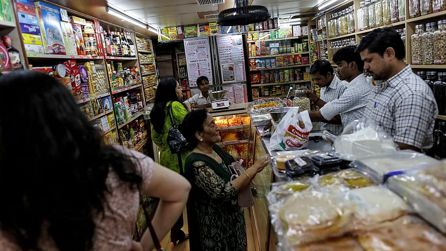 <div class="paragraphs"><p>FILE PHOTO: People shop inside a grocery store at a residential area in Mumbai, India June 13, 2016. </p></div>