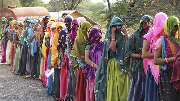 <div class="paragraphs"><p>Women wait in a long queue. </p></div>