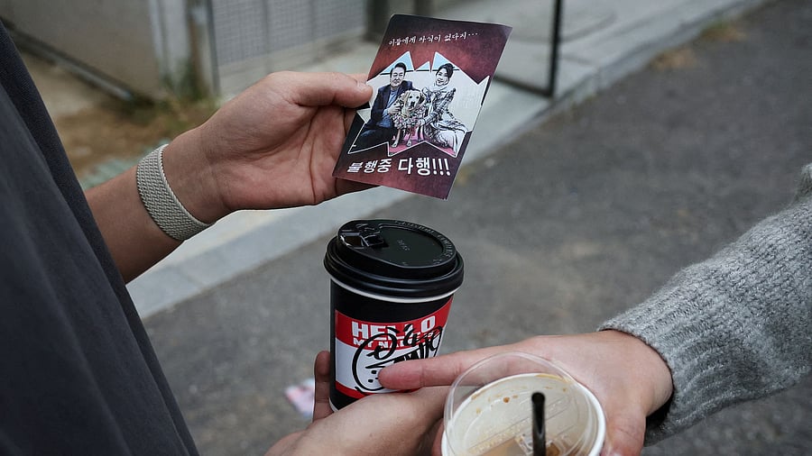 <div class="paragraphs"><p>People look at a North Korean propaganda leaflet denouncing South Korean President Yoon Suk Yeol and his wife Kim Keon Hee, apparently carried by balloons sent from North Korea, near the Presidential Office in Seoul, South Korea, October 24, 2024. </p></div>