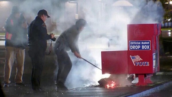 <div class="paragraphs"><p>First responders pull out the burning contents of a ballot box, used to collect early votes ahead of the Nov. 5 U.S. election, after it was set on fire in a suspected arson in Vancouver, Washington. </p></div>