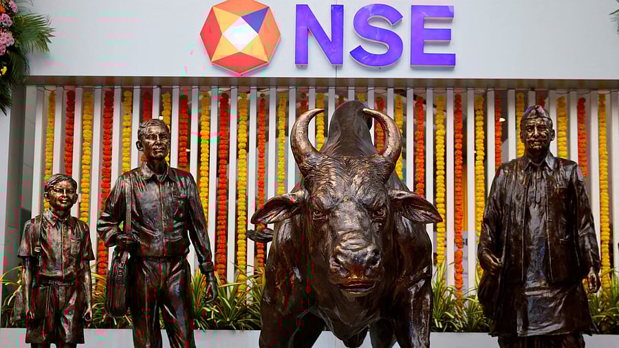 <div class="paragraphs"><p> Statues of people and a bull are seen next to the logo of the National Stock Exchange in Mumbai, India.</p></div>